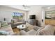 Cozy living room features plush seating, a ceiling fan and water views at 6061 Bahia Del Mar Blvd # 112, St Petersburg, FL 33715