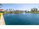Scenic community pond with fountain, lush landscaping, and condominium buildings in the background at 6061 Bahia Del Mar Blvd # 112, St Petersburg, FL 33715