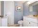 Charming bathroom featuring light blue wainscoting, stylish fixtures, and a decorative patterned floor, offering a fresh, clean design at 6915 Stones Throw N Cir # 3104, St Petersburg, FL 33710