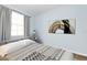 Bedroom with gray-toned walls, an art piece, and hardwood-style floors, offering a comfortable and modern retreat at 6915 Stones Throw N Cir # 3104, St Petersburg, FL 33710