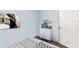 Light bedroom featuring wood-look floors, a modern dresser with decor, and abstract wall art at 6915 Stones Throw N Cir # 3104, St Petersburg, FL 33710