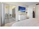Bright bedroom with sliding doors to the balcony, wooden floors, and a modern dresser, creating a cozy retreat at 6915 Stones Throw N Cir # 3104, St Petersburg, FL 33710