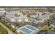 Overhead view of a community featuring manicured landscaping, parking, tennis courts and community pool at 6915 Stones Throw N Cir # 3104, St Petersburg, FL 33710
