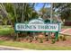 Stone's Throw Condominiums community sign surrounded by mature trees and manicured landscaping at 6915 Stones Throw N Cir # 3104, St Petersburg, FL 33710