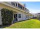 Exterior of building with patio, lawn, and a glimpse of the waterway behind it at 6915 Stones Throw N Cir # 3104, St Petersburg, FL 33710