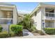 Exterior view of condo showcasing maintained landscaping and building entrances at 6915 Stones Throw N Cir # 3104, St Petersburg, FL 33710