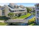 Beautiful waterfront condo featuring a canal view with a small bridge and lush landscaping at 6915 Stones Throw N Cir # 3104, St Petersburg, FL 33710