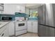 Corner kitchen with white cabinets, stainless steel appliances, and a window at 6915 Stones Throw N Cir # 3104, St Petersburg, FL 33710