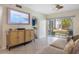 Inviting living room with tiled floors, modern furniture, and a sliding glass door to screened-in patio at 6915 Stones Throw N Cir # 3104, St Petersburg, FL 33710