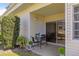 Covered patio with a table and chairs, sliding glass door, and exterior view at 6915 Stones Throw N Cir # 3104, St Petersburg, FL 33710