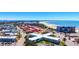 Beautiful aerial view of a bright white condo complex next to a white sandy beach at 7050 Sunset Way # 26, St Pete Beach, FL 33706