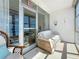 Inviting covered balcony featuring a comfortable seating area with windows and ample natural light at 7050 Sunset Way # 26, St Pete Beach, FL 33706