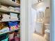 Functional bathroom with a closet stocked with towels, alongside a toilet, sink, and shower for convenience at 7050 Sunset Way # 26, St Pete Beach, FL 33706