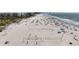 Wide sandy beach with volleyball nets and plenty of space for sunbathing near the water at 7050 Sunset Way # 26, St Pete Beach, FL 33706