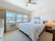 Bright bedroom with a large window offering a view of the building, featuring a comfortable bed and ample natural light at 7050 Sunset Way # 26, St Pete Beach, FL 33706