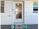 Charming front door with custom beach themed welcome mat, and unit number 26 at 7050 Sunset Way # 26, St Pete Beach, FL 33706