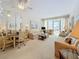 Spacious living room and dining area featuring a ceiling fan, and an abundance of natural light at 7050 Sunset Way # 26, St Pete Beach, FL 33706