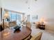 Bright living room and dining area featuring a ceiling fan and sliding door access to screened lanai at 7050 Sunset Way # 26, St Pete Beach, FL 33706