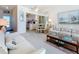 Bright living room with neutral tones, comfortable seating, and a glimpse into the kitchen area at 7050 Sunset Way # 26, St Pete Beach, FL 33706