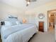Bright main bedroom featuring a comfortable bed, closet and ensuite bathroom at 7050 Sunset Way # 26, St Pete Beach, FL 33706