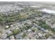 A scenic aerial captures a residential area nestled near a stream, a shopping center and local amenities at 7314 Princeton Dr, Hudson, FL 34667