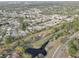 A scenic aerial shot highlights a quiet community near a stream surrounded by trees and well-kept properties at 7314 Princeton Dr, Hudson, FL 34667