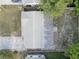 Aerial view of a property showcasing the roof, driveway, and surrounding landscape at 7314 Princeton Dr, Hudson, FL 34667