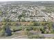 An elevated view displays a quiet neighborhood near a winding creek amidst lush green trees at 7314 Princeton Dr, Hudson, FL 34667