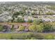 An aerial view displays the serene neighborhood with tree-lined streets and well-kept homes at 7314 Princeton Dr, Hudson, FL 34667