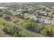 An elevated view captures a peaceful neighborhood bordered by lush trees and a tranquil stream at 7314 Princeton Dr, Hudson, FL 34667