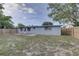 Rear view of the home displaying the backyard, patio, and exterior features at 7314 Princeton Dr, Hudson, FL 34667
