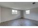 Sunlit bedroom featuring hard surface floors and dual windows at 7314 Princeton Dr, Hudson, FL 34667