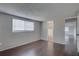 Bright bedroom with hardwood floors, white trim, and ample natural light from a large window at 7314 Princeton Dr, Hudson, FL 34667