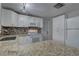 Well-lit kitchen with granite counters, white cabinets, and modern appliances at 7314 Princeton Dr, Hudson, FL 34667