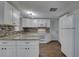 Charming kitchen featuring granite counters, tile backsplash, and white appliances at 7314 Princeton Dr, Hudson, FL 34667