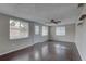 Bright living room with wood floors, ceiling fan, and natural light at 7314 Princeton Dr, Hudson, FL 34667