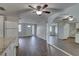 Open-concept kitchen and living area with hardwood floors, ceiling fan, and neutral tones at 7314 Princeton Dr, Hudson, FL 34667