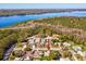 Aerial view of the property with a lake in the background and home's location in the neighborhood at 803 Helmsman Way, Palm Harbor, FL 34685