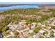 Aerial view of the property with a lake in the background and home's location in the neighborhood at 803 Helmsman Way, Palm Harbor, FL 34685