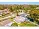 Aerial view of the home showcasing the roof, screened in lanai, driveway, and surrounding trees at 803 Helmsman Way, Palm Harbor, FL 34685