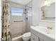 Bathroom featuring tiled walk-in shower, a white vanity, and good natural light at 803 Helmsman Way, Palm Harbor, FL 34685