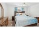 Cozy bedroom with light blue accents, a ceiling fan, and a comfortable bed at 803 Helmsman Way, Palm Harbor, FL 34685