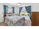 Bedroom featuring large window, ceiling fan, and cozy decor at 803 Helmsman Way, Palm Harbor, FL 34685