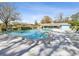 Large community pool with clear blue water, surrounded by lounge chairs and a clubhouse for relaxation at 803 Helmsman Way, Palm Harbor, FL 34685