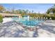 Inviting community pool with clear blue water, ample seating, and a picturesque mural in the background at 803 Helmsman Way, Palm Harbor, FL 34685