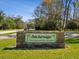 Anchorage, a deed restricted 55+ community sign with tropical palms on a manicured lawn under a sunny sky at 803 Helmsman Way, Palm Harbor, FL 34685