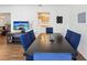 Open dining room featuring wood-look floors, modern decor, and open access to the kitchen at 803 Helmsman Way, Palm Harbor, FL 34685