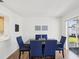 Dining room featuring wood floors, modern art, and sliding glass door to the backyard at 803 Helmsman Way, Palm Harbor, FL 34685