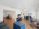 Open-concept living room with wood-look floors, ceiling fan, and an open floor plan at 803 Helmsman Way, Palm Harbor, FL 34685