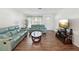 Bright living room featuring wood floors, a modern ceiling fan, and lots of natural light at 803 Helmsman Way, Palm Harbor, FL 34685